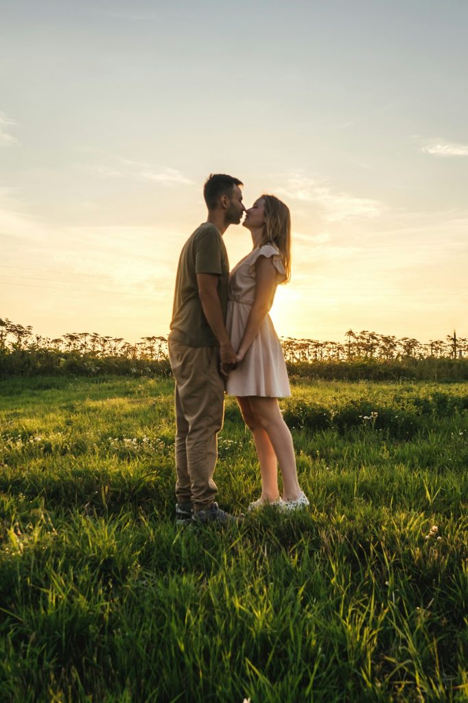 Loving couple in the field. Sunset.
