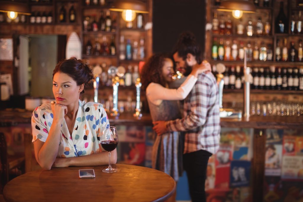 Jealous woman ignoring affectionate couple