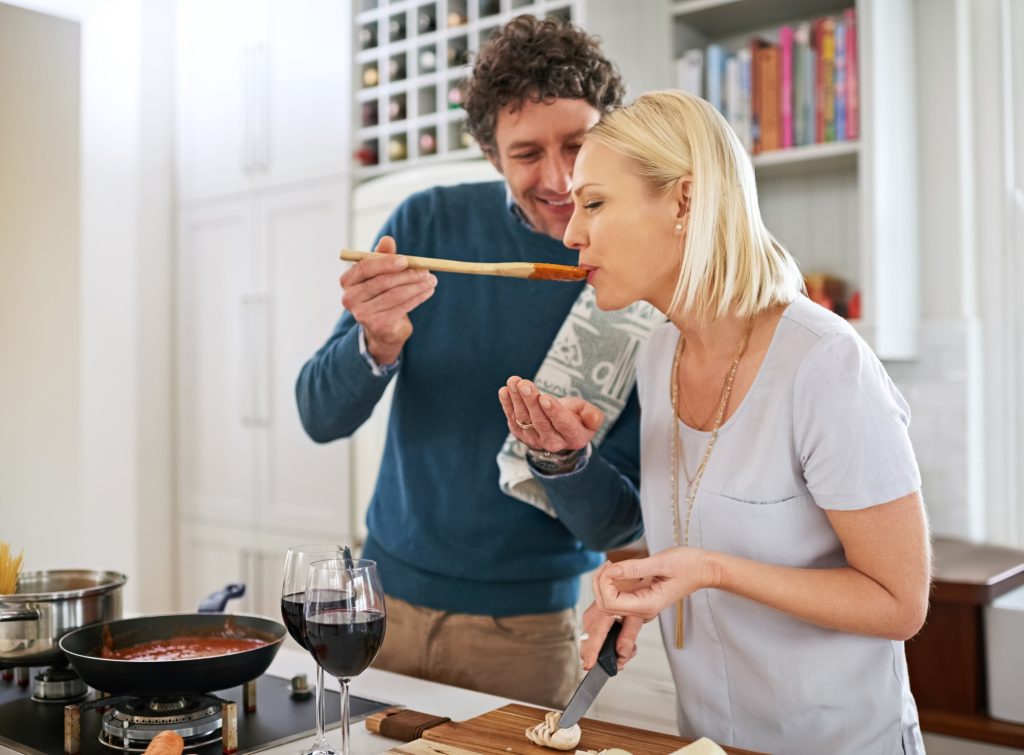 Shot of a happy couple cooking dinner together in their kitchen